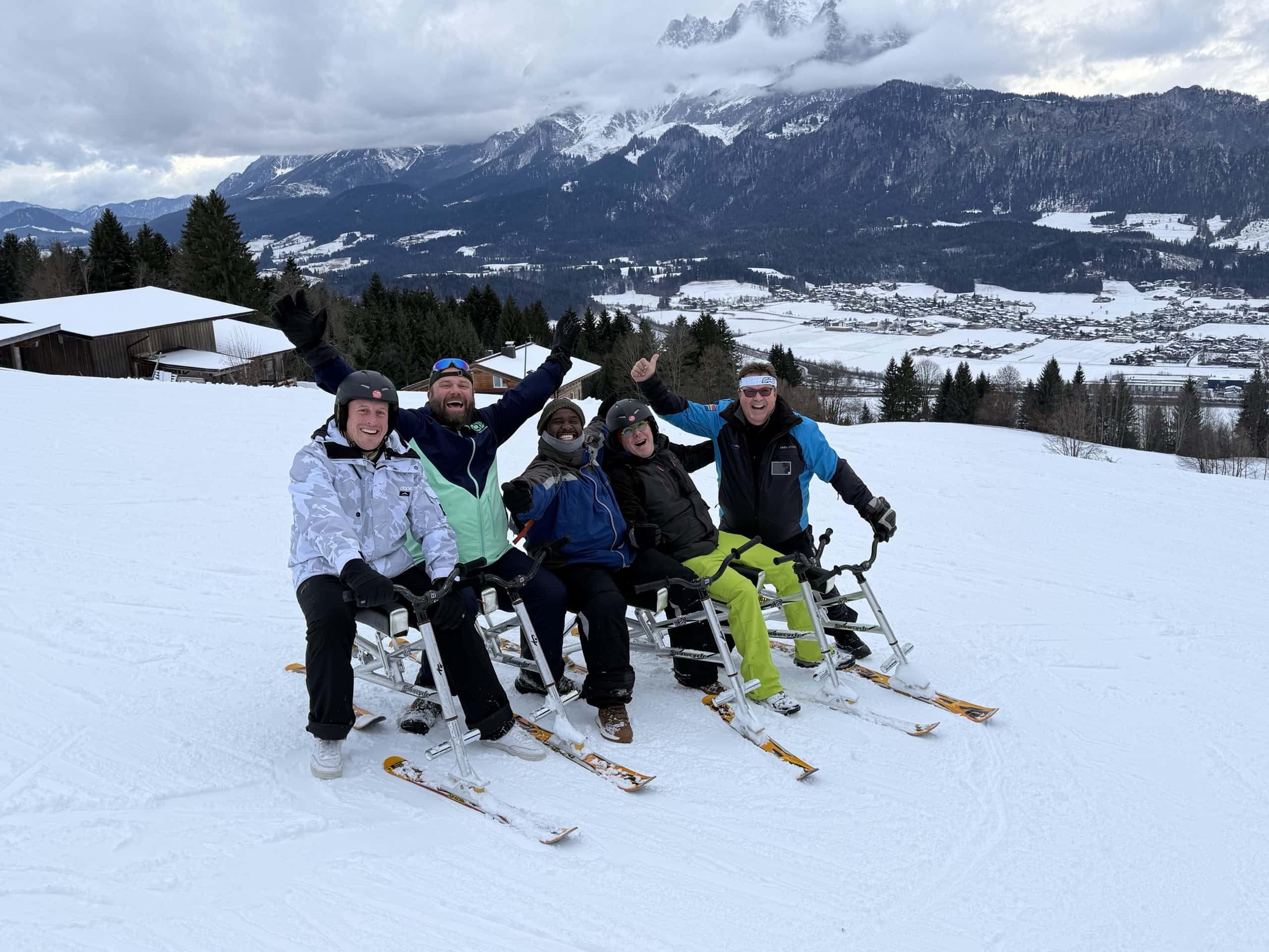 The Wilder Kaiser range behind a group on the snow above St. Johann in Tirol